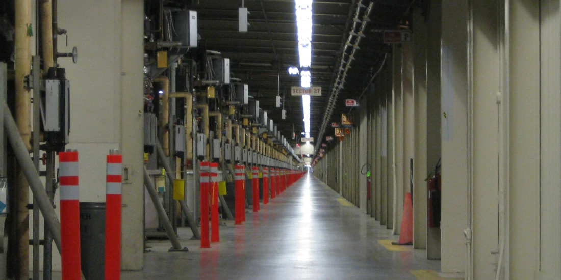 A tunnel with hundreds of klystrons receeding to a vanishing point (at the Stanford Linear Accelerator)